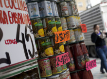 A woman walks in front of a supermarket in Caracas